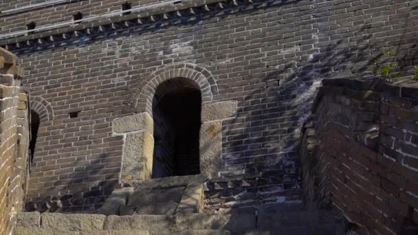 Slowmotion steadicam disparo de la Gran Muralla de China que se eleva por el lado de la montaña. Cámara se mueve hacia la entrada de la torre de vigilancia — Vídeos de Stock