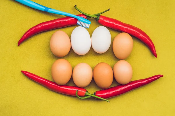 Eggs and red pepper in the form of a mouth with teeth. White eggs are bleached teeth. Yellow eggs - before bleaching. Teeth whitening before and after — Stock Photo, Image