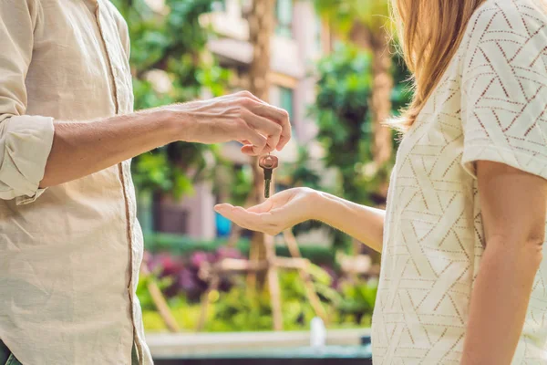 Real estate agent giving keys to apartment owner, buying selling property business. Close up of male hand taking house key from realtor. Mortgage for purchasing flat, getting access to own home — Stock Photo, Image