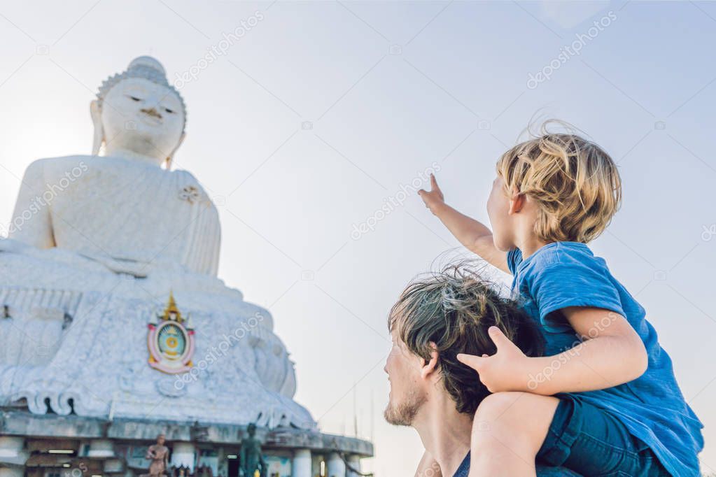 Father and son tourists on the Big Buddha statue. Was built on a high hilltop of Phuket Thailand Can be seen from a distance