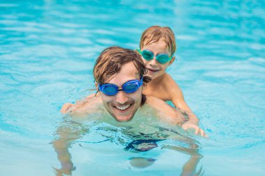 Baba ve oğlu içinde gözlük yüzme havuzunda eğlenin
