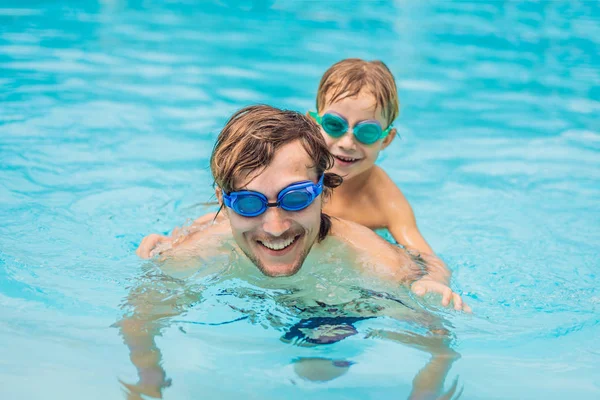 Baba ve oğlu içinde gözlük yüzme havuzunda eğlenin