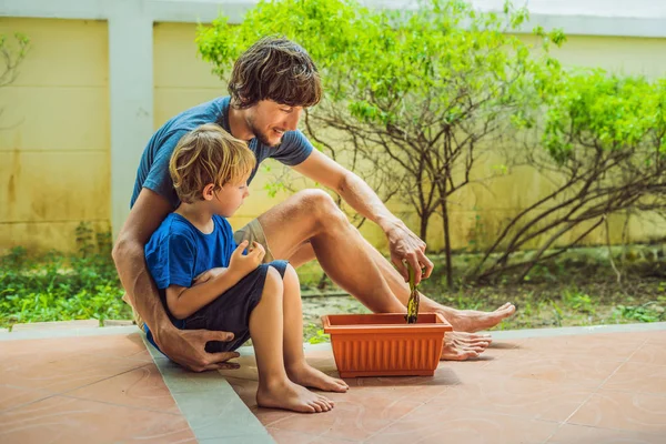 Father and son gardening in the garden near the house — Stock Photo, Image