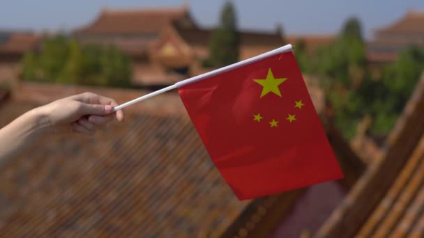 Woman holding a small flag of China in her hands. Travel to China concept — Stock Video