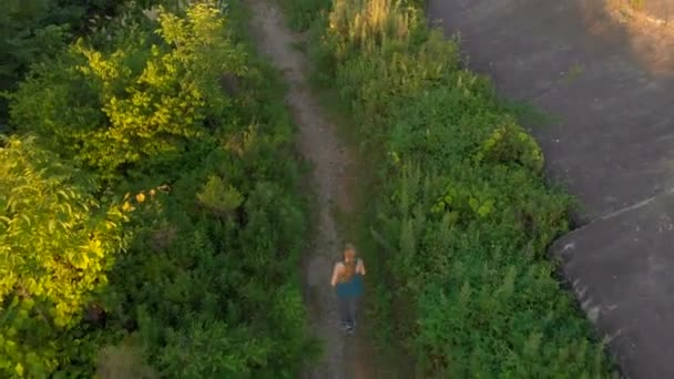 Aerial shot of a young woman running at the territory of an old 1st world war fortress during sunset, sunrise — Stock Video