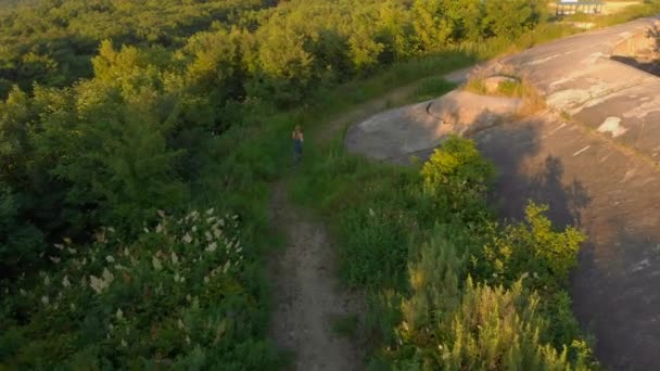 Aerial shot of a young woman running at the territory of an old 1st world war fortress during sunset, sunrise — Stock Video
