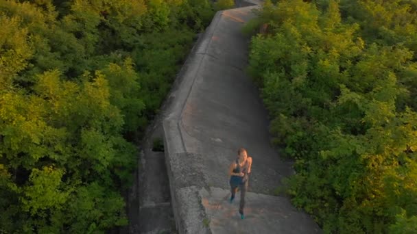 Légi felvétel, egy fiatal nő, egy régi 1. világ tetején fut a fortress háború során naplemente, Napkelte — Stock videók