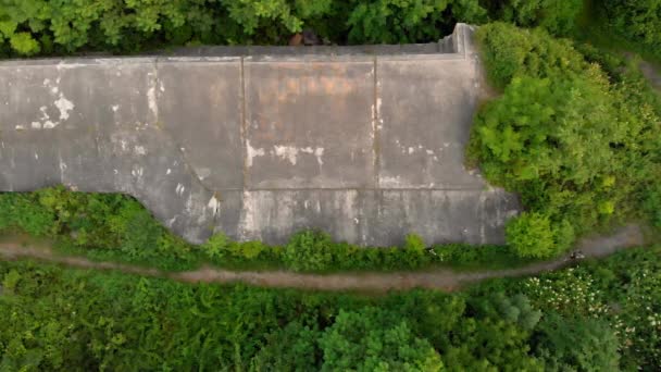 Aerial shot of a young man running at the territory of an old 1st world war fortress during sunset, sunrise — Stock Video