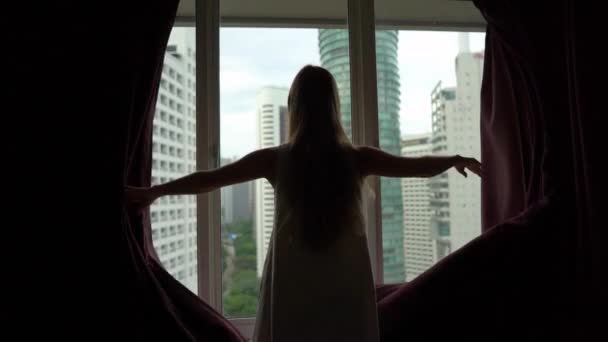 Superslowmotion shot των επιτυχημένων πλούσια νεαρή γυναίκα άνοιγμα κουρτίνες στο διαμέρισμά της στο κέντρο της πόλης με πανοραμική θέα. Σχέδιο επιτυχίας. Έννοια εκπληρωμένη ζωή — Αρχείο Βίντεο