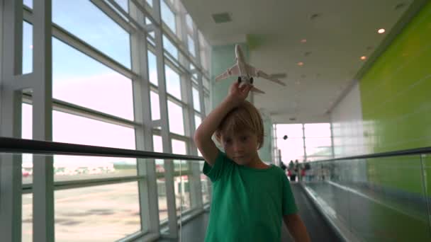 Slowmotion Shot Małego Chłopca Który Porusza Się Travolator Przez Lotnisko — Wideo stockowe