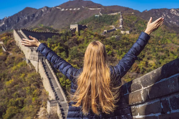 Happy cheerful joyful tourist woman at Great Wall of China having fun on travel smiling laughing and dancing during vacation trip in Asia. Girl visiting and sightseeing Chinese destination — Stock Photo, Image