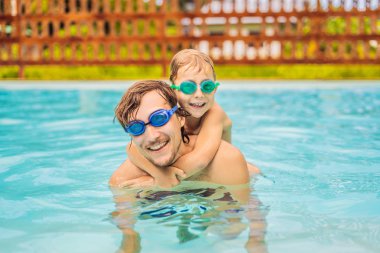 Baba ve oğlu içinde gözlük yüzme havuzunda eğlenin