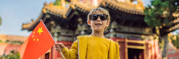 Enjoying vacation in China. Young boy with national chinese flag in Forbidden City. Travel to China with kids concept. Visa free transit 72 hours, 144 hours in China BANNER, LONG FORMAT
