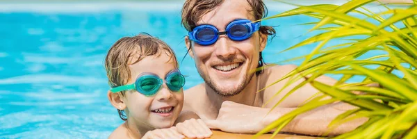 Dad and son in swimming Goggles have fun in the pool BANNER, LONG FORMAT