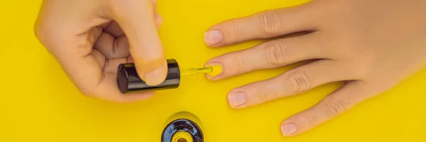 Woman Hands Care. Top View Of Beautiful Smooth Womans Hands With Professional Nail Care Tools For Manicure On yellow Background. Closeup Of Healthy Female Nails With yellow Nail Polish. High — Stock Photo, Image