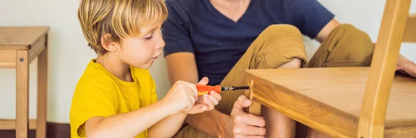 Father and son assembling furniture. Boy helping his dad at home. Happy Family concept BANNER, LONG FORMAT — Stock Photo, Image