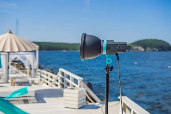 Cinema lights on a commercial video production shoot with lounge zone by the sea