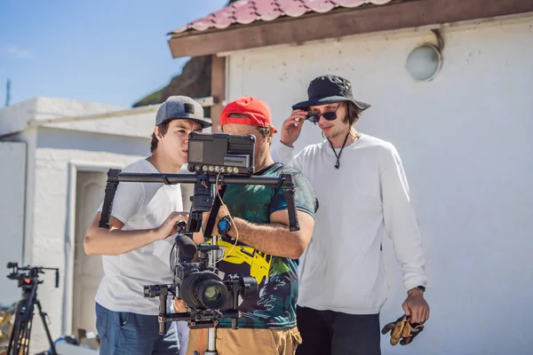 camera operator, director and dp discuss the process of a commercial video shoot