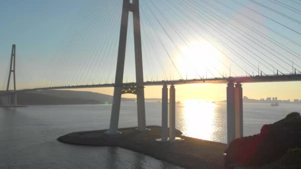 Aerial shot of the Russkiy cable bridge during sunset in a city of Vladivostok, Russia — Stock Video