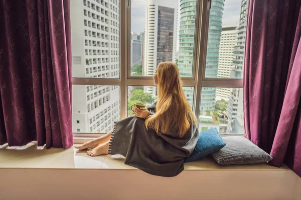 Donna avvolta in una coperta e guardando la grande città — Foto Stock