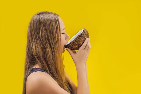 Young woman doing oil pulling over yellow background — Stock Photo, Image