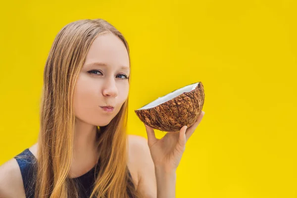 Young woman doing oil pulling over yellow background — Stock Photo, Image