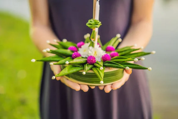 Young woman celebrates Loy Krathong, Runs on the water. Loy Krathong festival, People buy flowers and candle to light and float on water to celebrate the Loy Krathong festival in Thailand