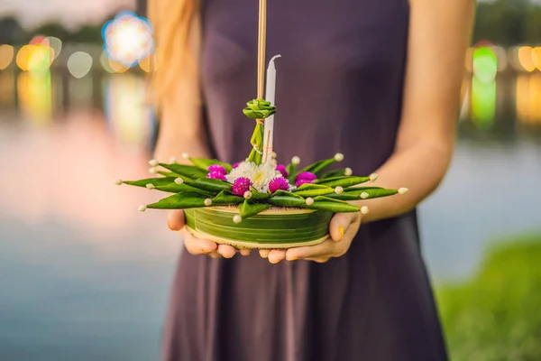 Young woman celebrates Loy Krathong, Runs on the water. Loy Krathong festival, People buy flowers and candle to light and float on water to celebrate the Loy Krathong festival in Thailand