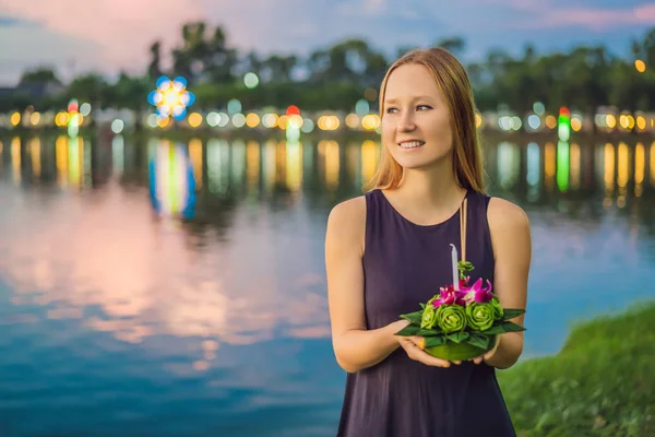 Young woman celebrates Loy Krathong, Runs on the water. Loy Krathong festival, People buy flowers and candle to light and float on water to celebrate the Loy Krathong festival in Thailand