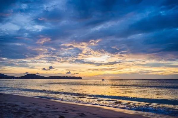 Beautiful yellow and blue sunset over the sea and the beach