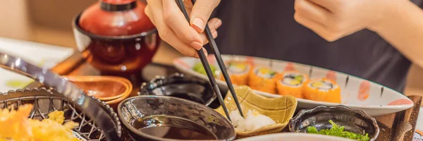 Woman eating japanese food in a japanese food restaurant BANNER, LONG FORMAT — Stock Photo, Image
