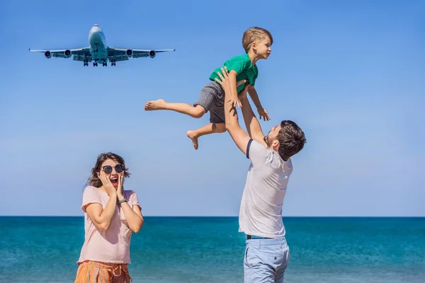 Happy family fun on the beach watching the landing planes. Traveling on an airplane with kids concept. Text space. Island Phuket in Thailand. Impressive paradise. Hot beach Mai Khao. Amazing landscape — Stock Photo, Image