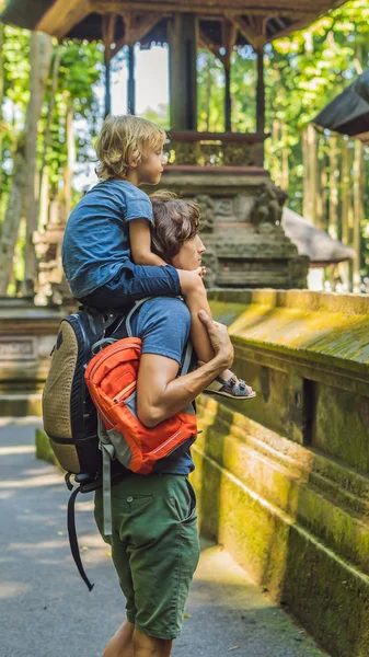 Dad and son travelers discovering Ubud forest in Monkey forest, Bali Indonesia. Traveling with children concept VERTICAL FORMAT for Instagram mobile story or stories size. Mobile wallpaper — Stock Photo, Image