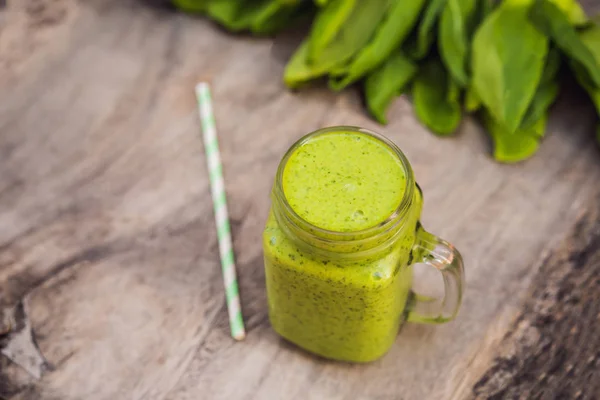 Ginger green apple smoothie on concrete background. It can be used as a background