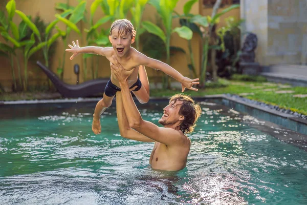 Dad and son have fun in the pool