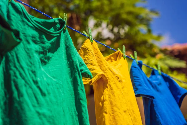Многоцветные рубашки на бельевой верёвке в солнечный день — стоковое фото