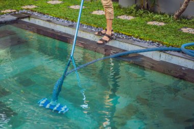 Cleaner of the swimming pool . Man in a blue shirt with cleaning equipment for swimming pools. Pool cleaning services clipart