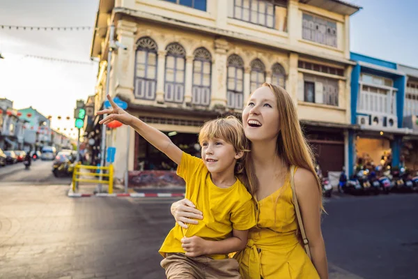 Mom and son tourists on the Street in the Portugese style Romani in Phuket Town. Also called Chinatown or the old town. Traveling with kids concept — Stock Photo, Image