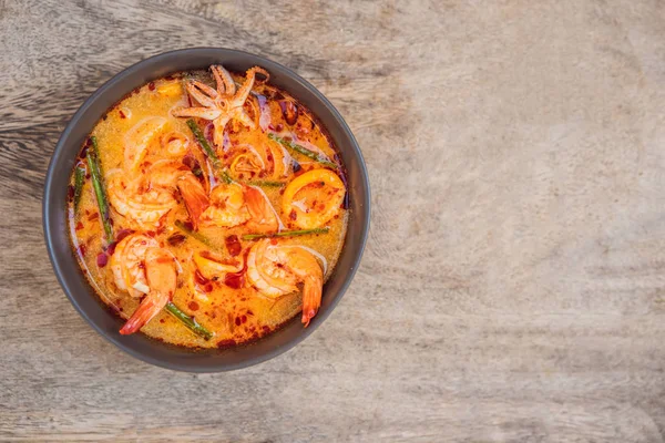 Sopa de erva de camarão e limão com cogumelos, Tom Yam Kung, comida tailandesa em fundo de madeira, vista superior — Fotografia de Stock