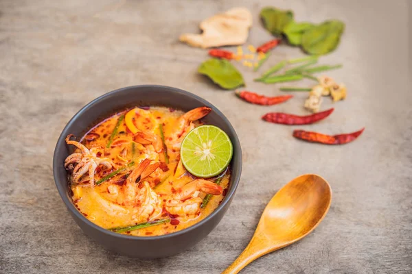 Prawn and lemon grass soup with mushrooms,Tom Yam Kung ,thai food in wooden background, top view