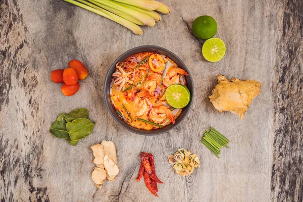Prawn and lemon grass soup with mushrooms,Tom Yam Kung ,thai food in wooden background, top view