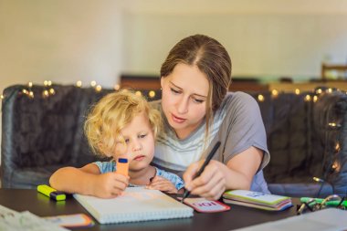 Bir öğretmen, ev eğitimiyle ilgili bir öğretmen ve masada bir eğitmen. Ya da anne ve kızı. Evde