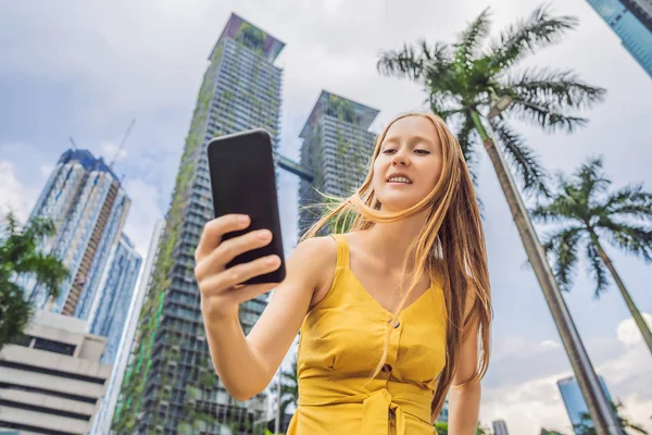 Vrouw toerist met behulp van de navigatie-app op de mobiele telefoon. Navigatiekaart op een smartphone in een grote stad — Stockfoto