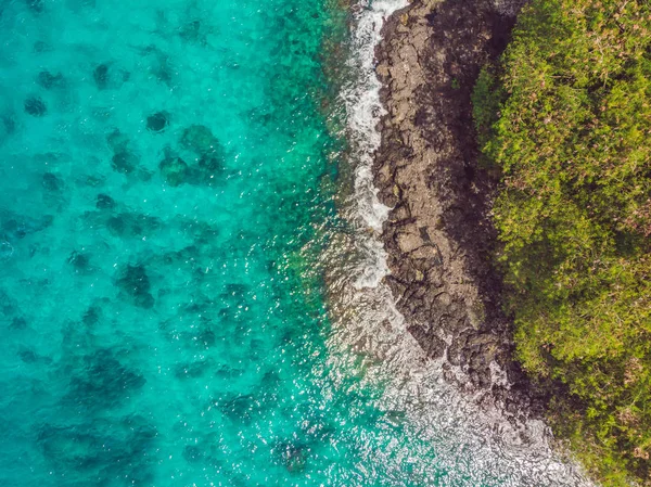 Bahía de mar con agua turquesa y una pequeña playa blanca. Hermosa laguna e isla volcánica cubierta de denso bosque, vista desde arriba — Foto de Stock