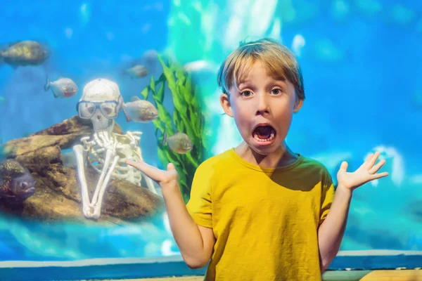 El chico se asustó Esqueleto y piraña en un acuario — Foto de Stock