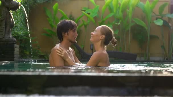 Young couple woman and man have fun in their private swimming pool. Honeymoon concept — Stock Video