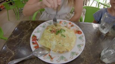 Aile geleneksel Malezya ve Endonezya gıda yeme - nasi goreng kızarmış yumurta sarılmış. Malezya ve Endonezya konseptine seyahat