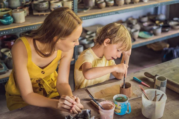 Mother and son doing ceramic pot in pottery workshop — Stock Photo, Image