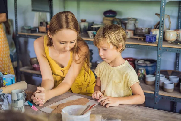 Mãe e filho fazendo pote de cerâmica na oficina de cerâmica — Fotografia de Stock