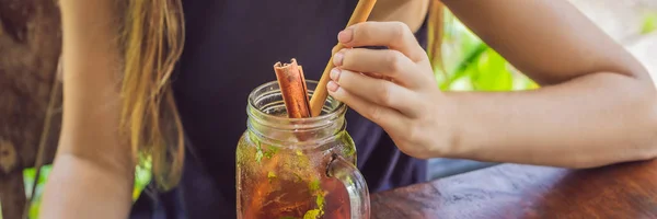 Young woman drinking cold tea with cinnamon in rice field BANNER, LONG FORMAT — Stock Photo, Image